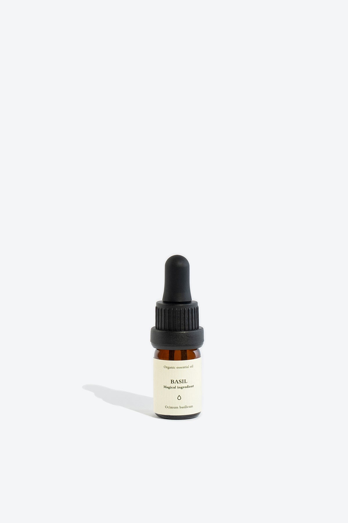 BASIL essential oil bottle, label showing Ocimum basilicum