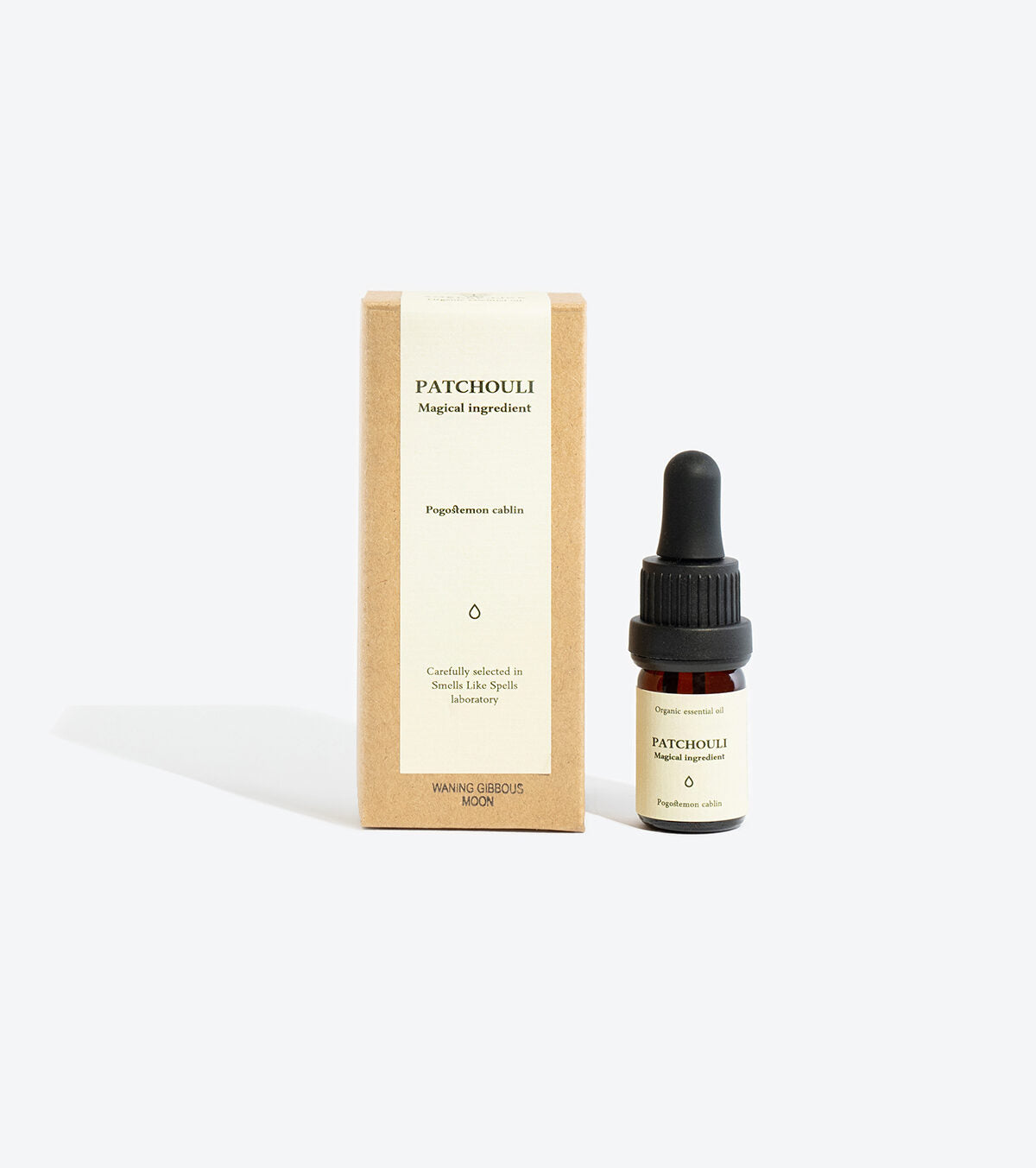 Patchouli essential oil bottle styled with ritual card