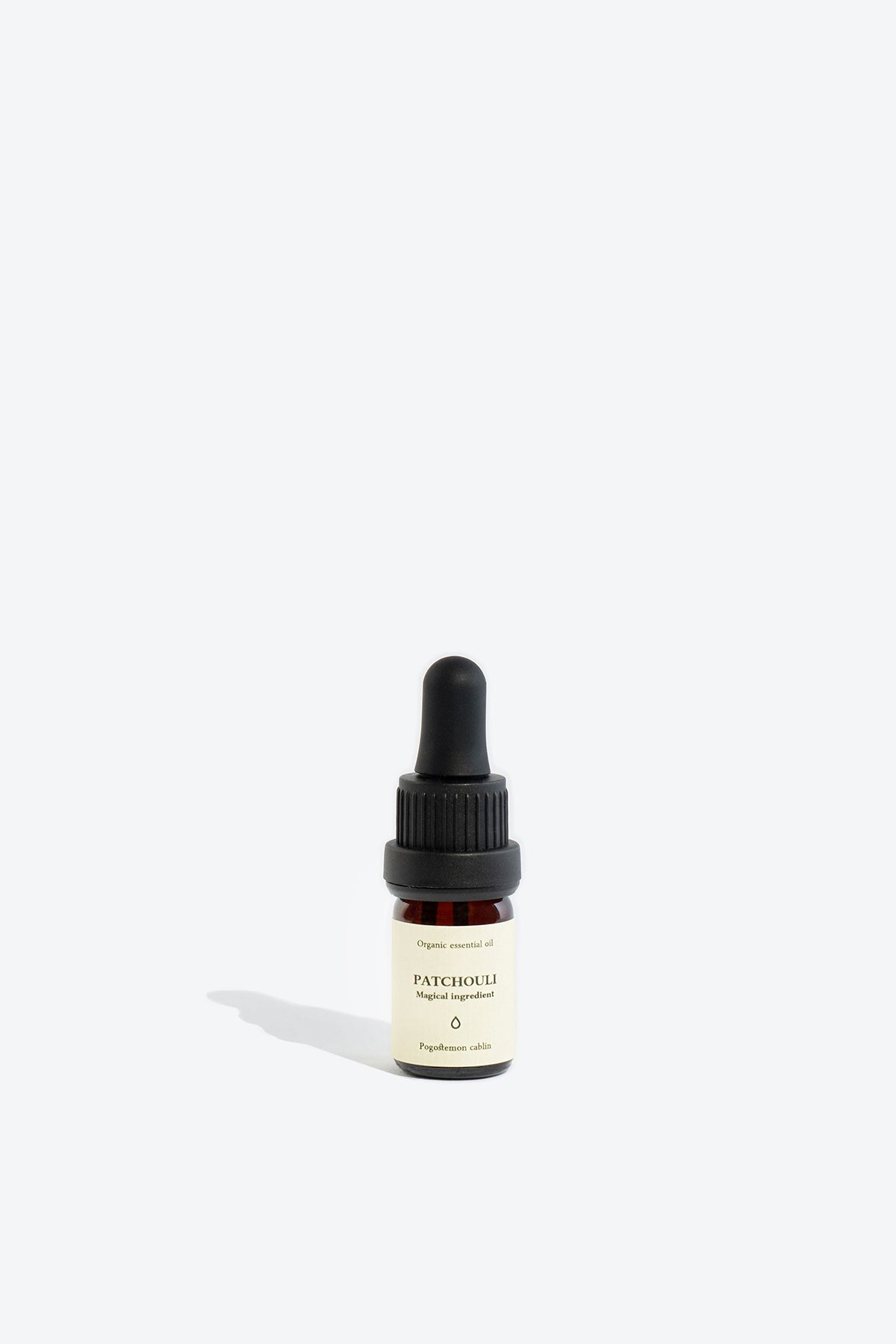 Close-up of patchouli essential oil glass pipette and label
