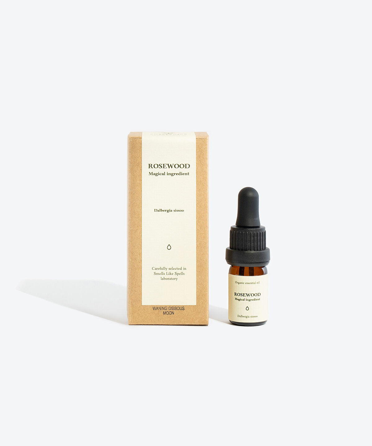 Rosewood essential oil bottle styled with ritual card