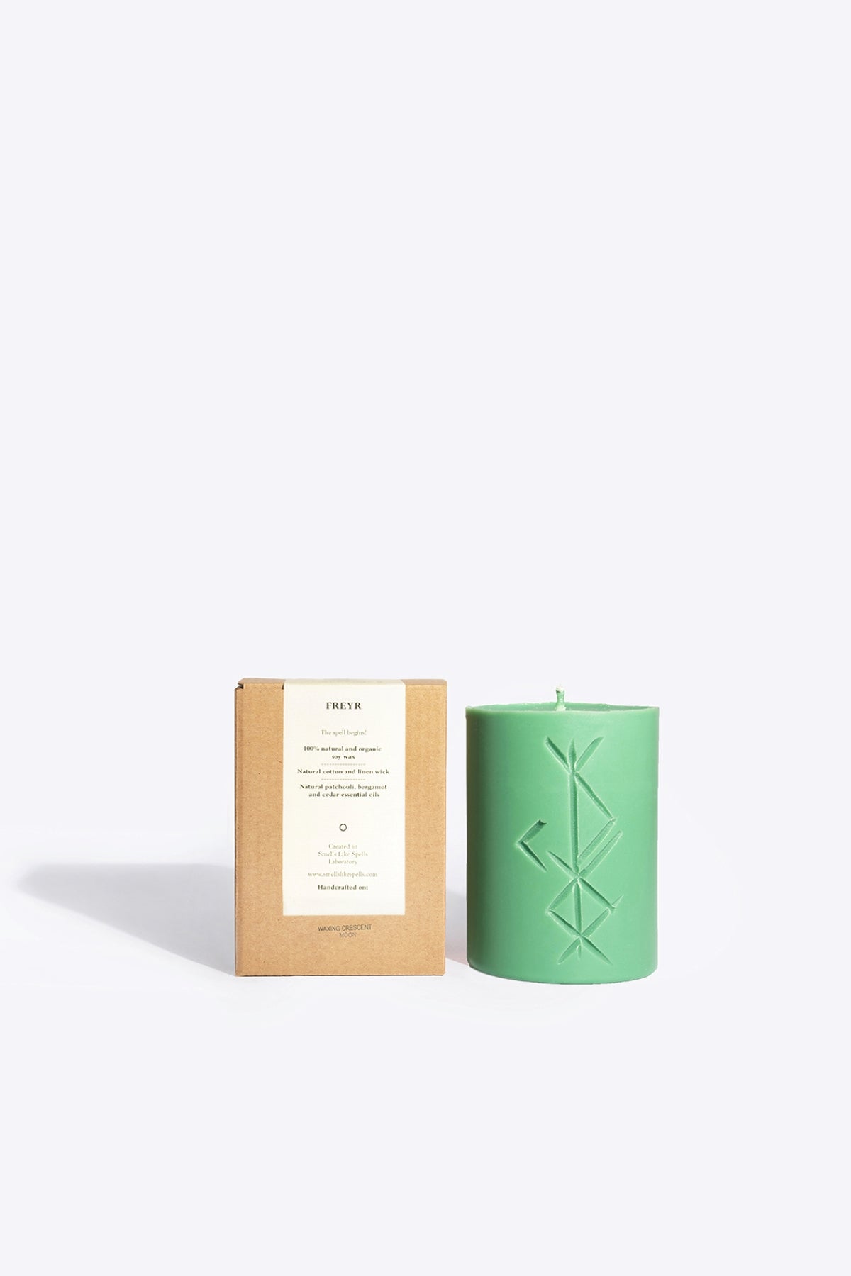 FREYR soy wax rune candle, front view showing carved rune symbol