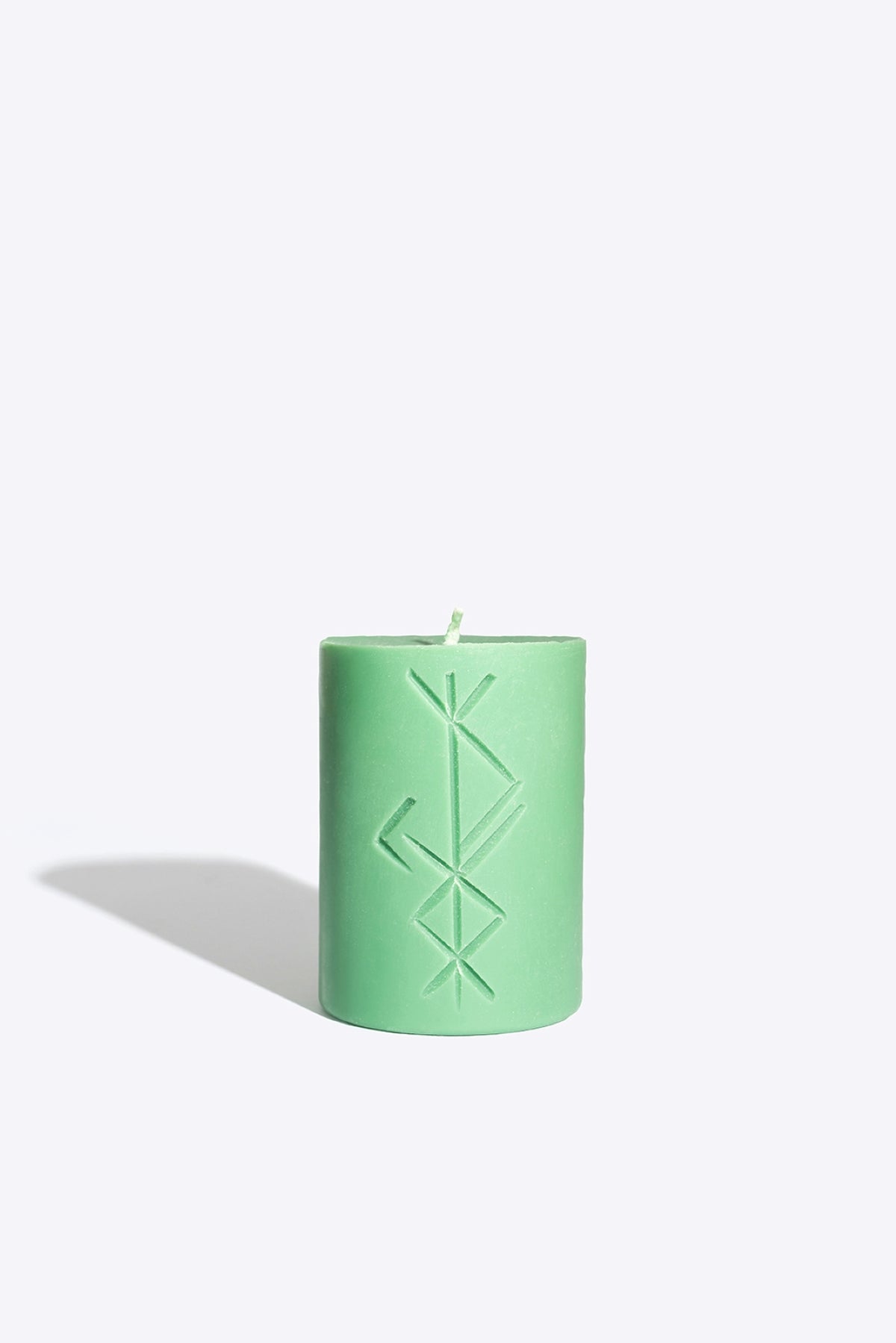 Close-up of FREYR rune candle wax and wick