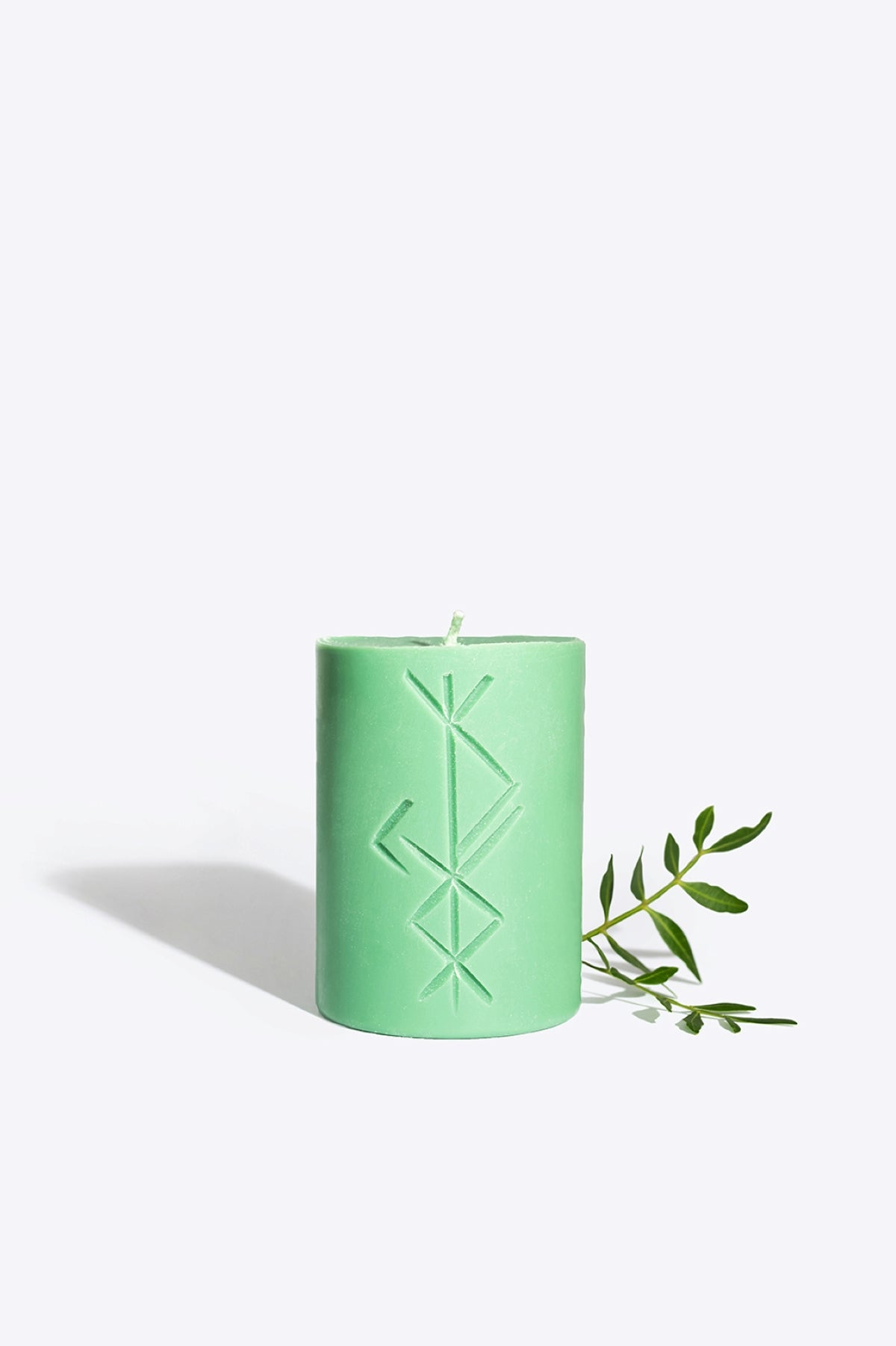 FREYR rune candle lit, warm glow for a prosperity ritual