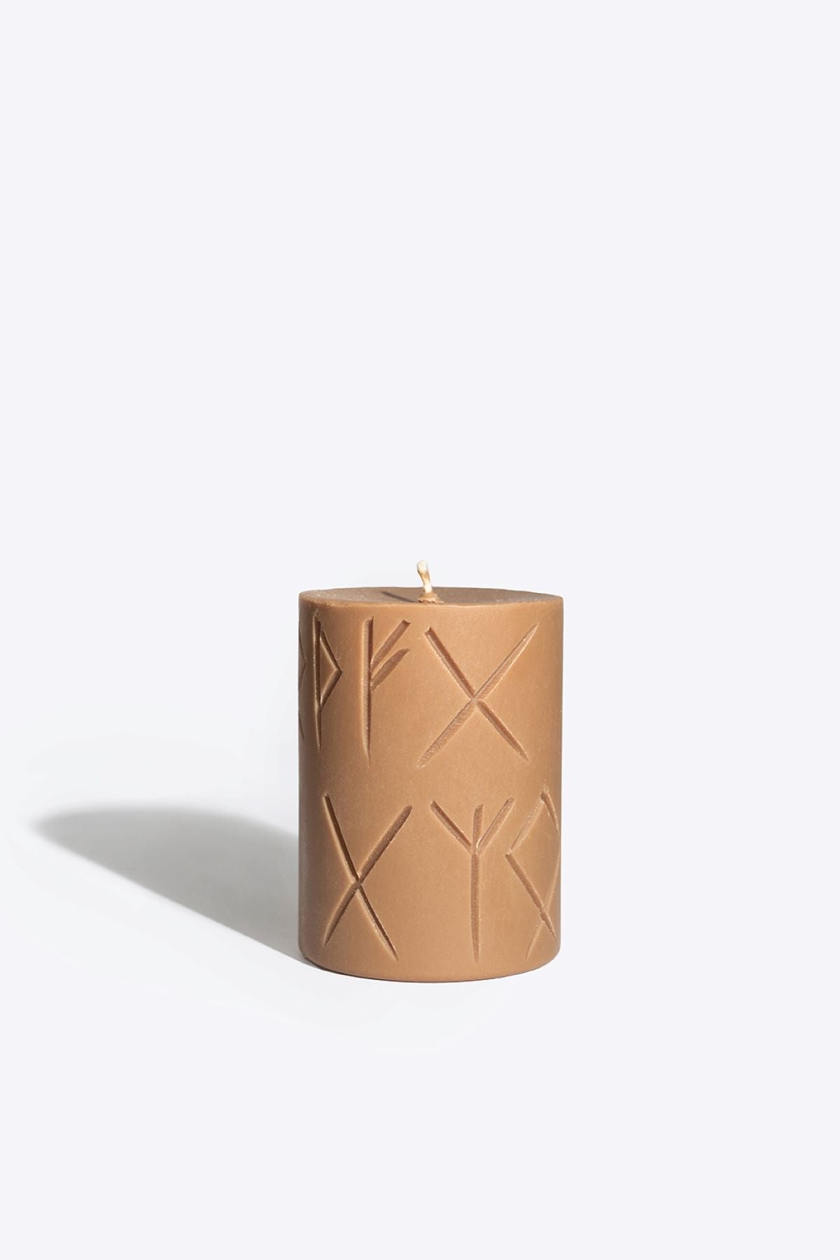 Close-up of FRIGGA rune candle wax and wick