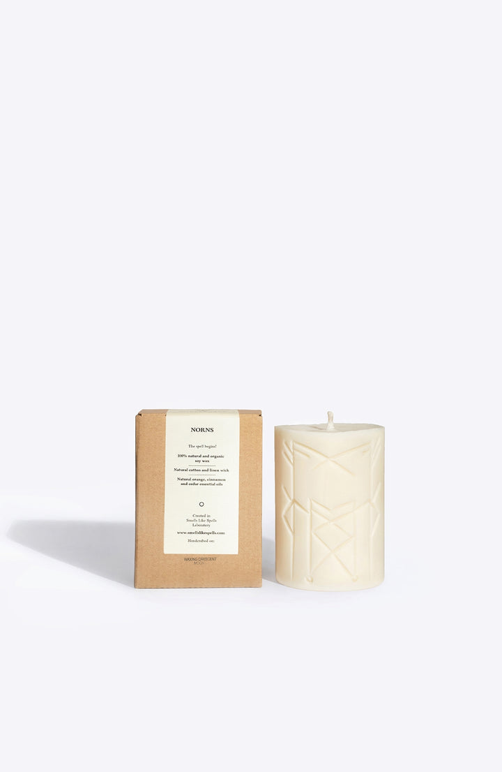 NORNS soy wax rune candle, front view showing carved rune symbol