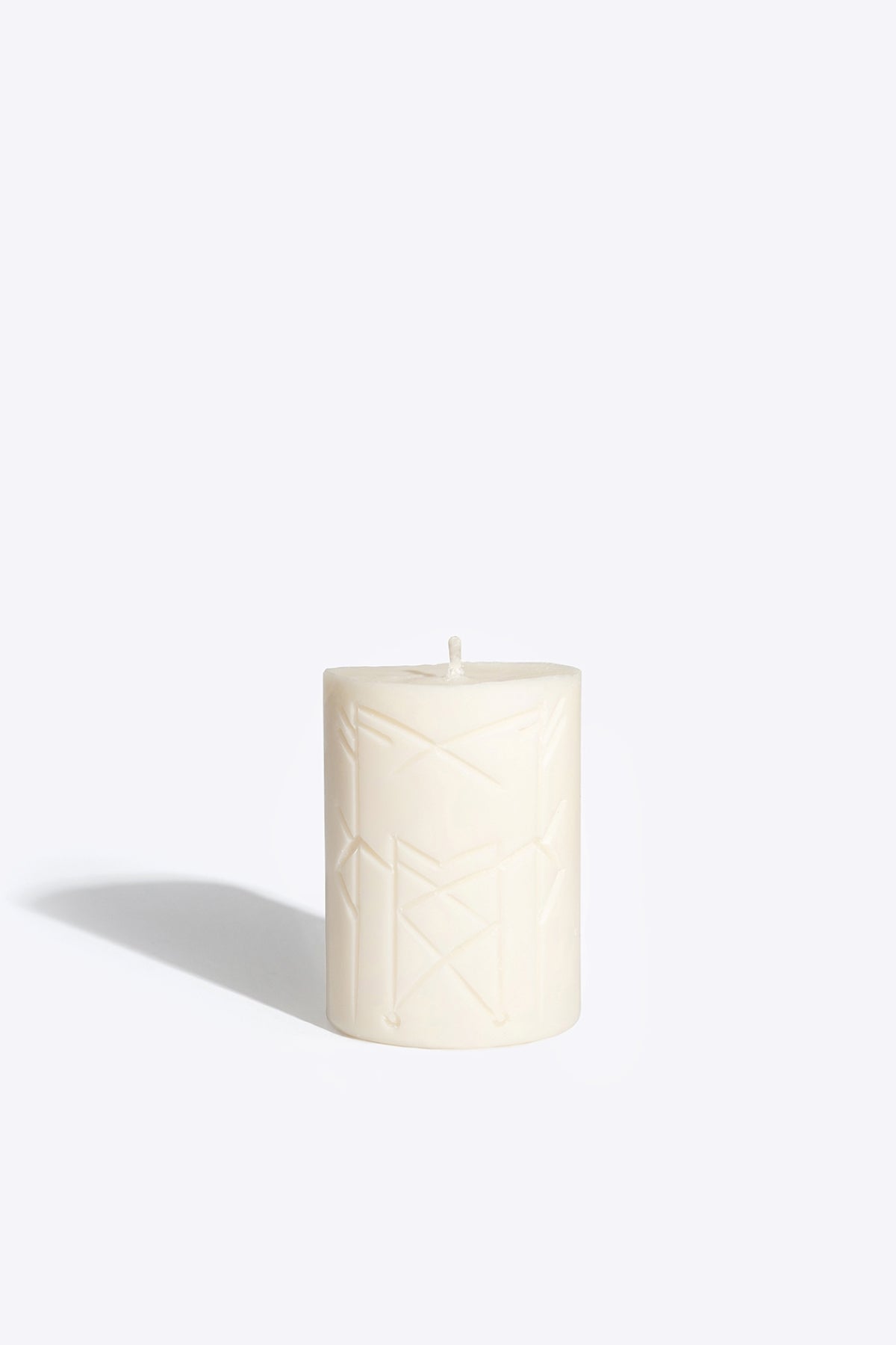 Close-up of NORNS rune candle wax and wick