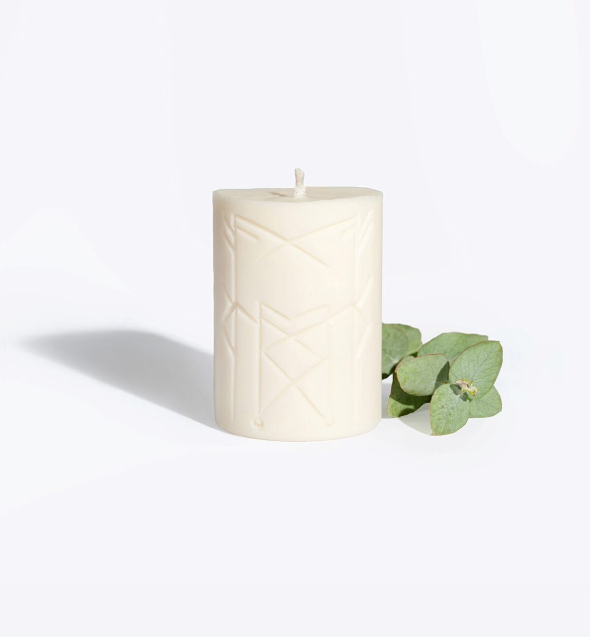 NORNS rune candle lit, warm glow for a luck and destiny ritual