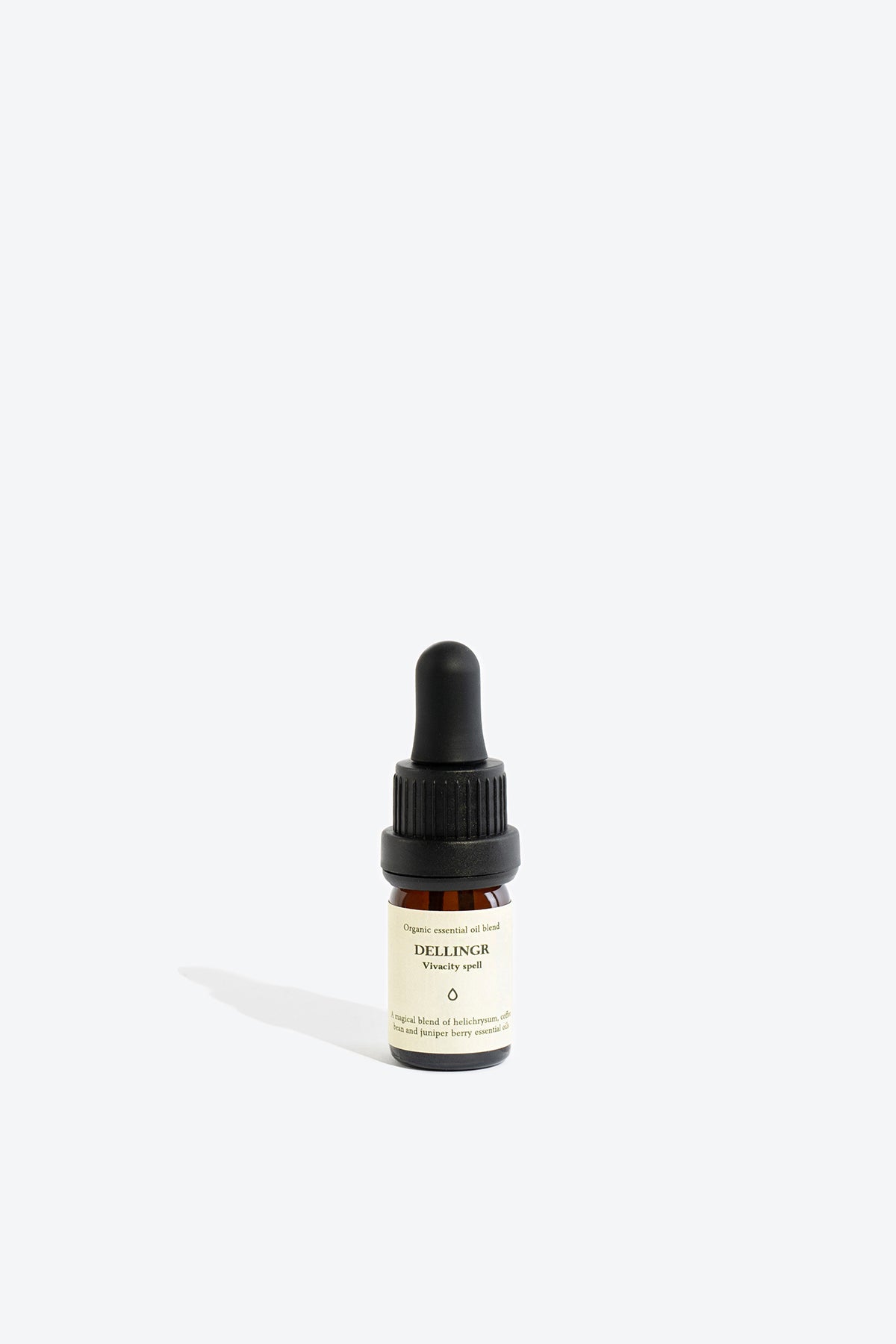 Close-up of DELLINGR essential oil blend bottle and label
