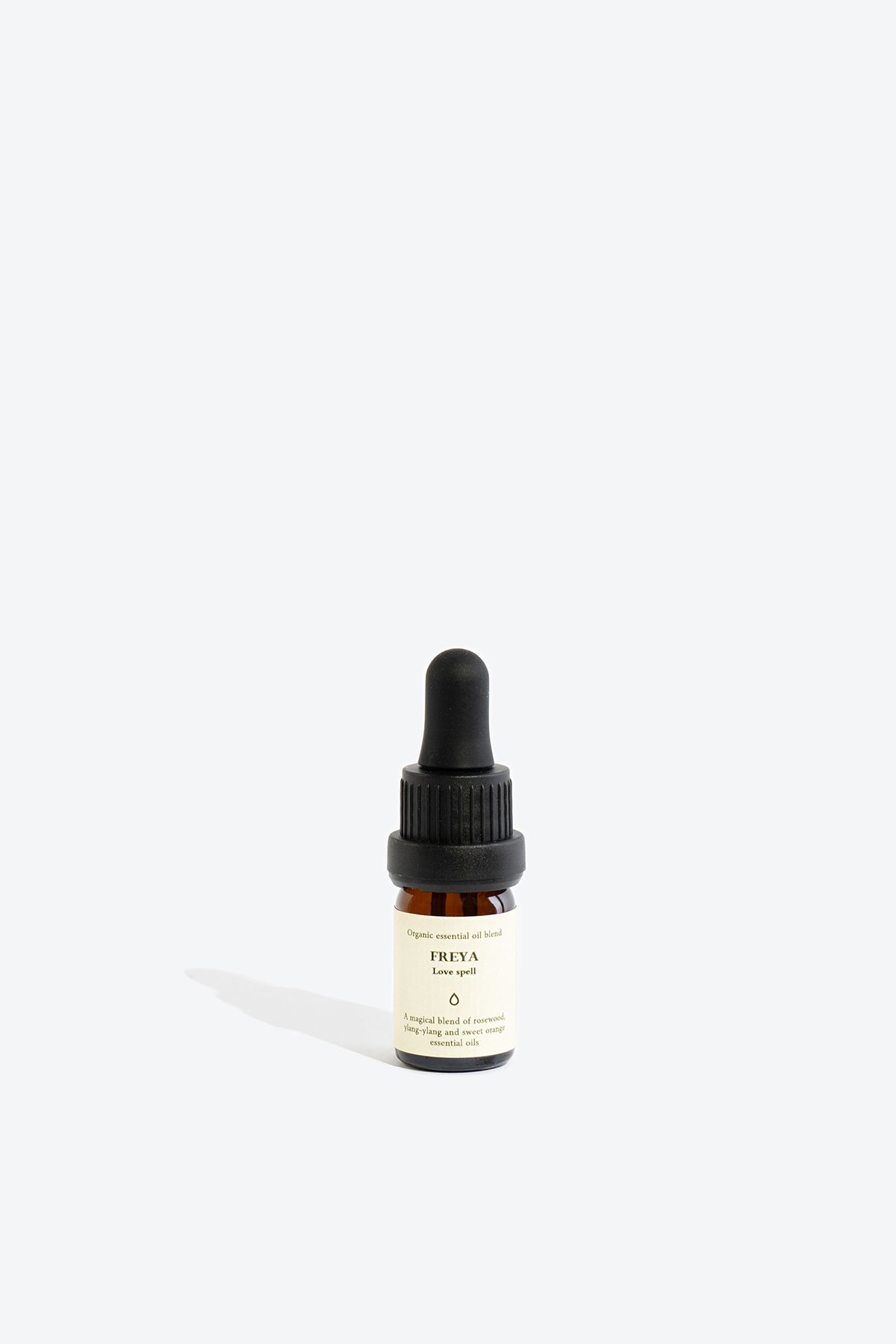 Close-up of FREYA essential oil blend bottle and label