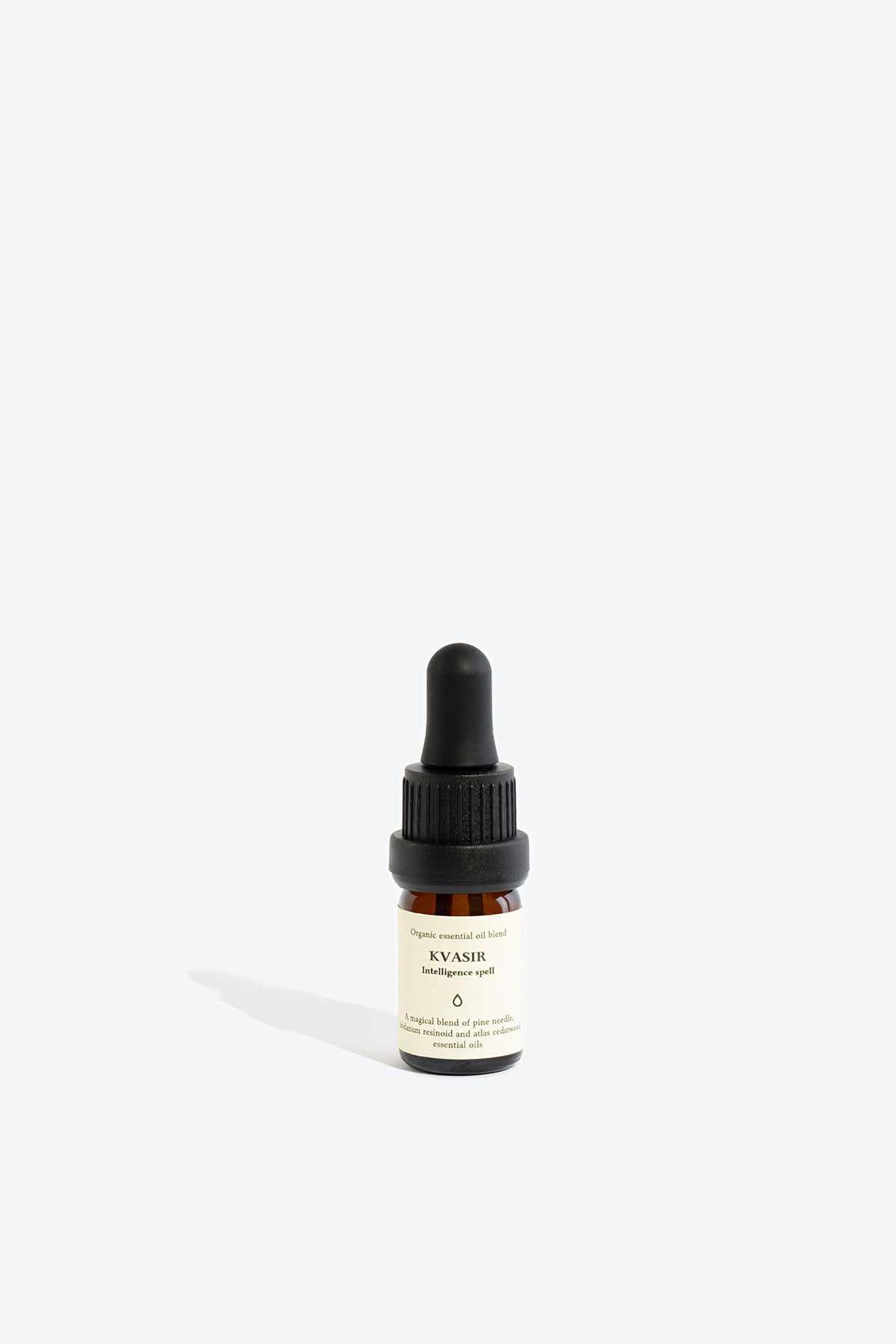 Close-up of KVASIR essential oil blend bottle and dropper