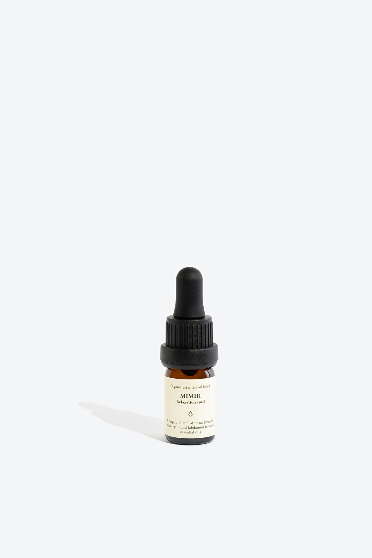 Close-up of MIMIR essential oil blend bottle and label