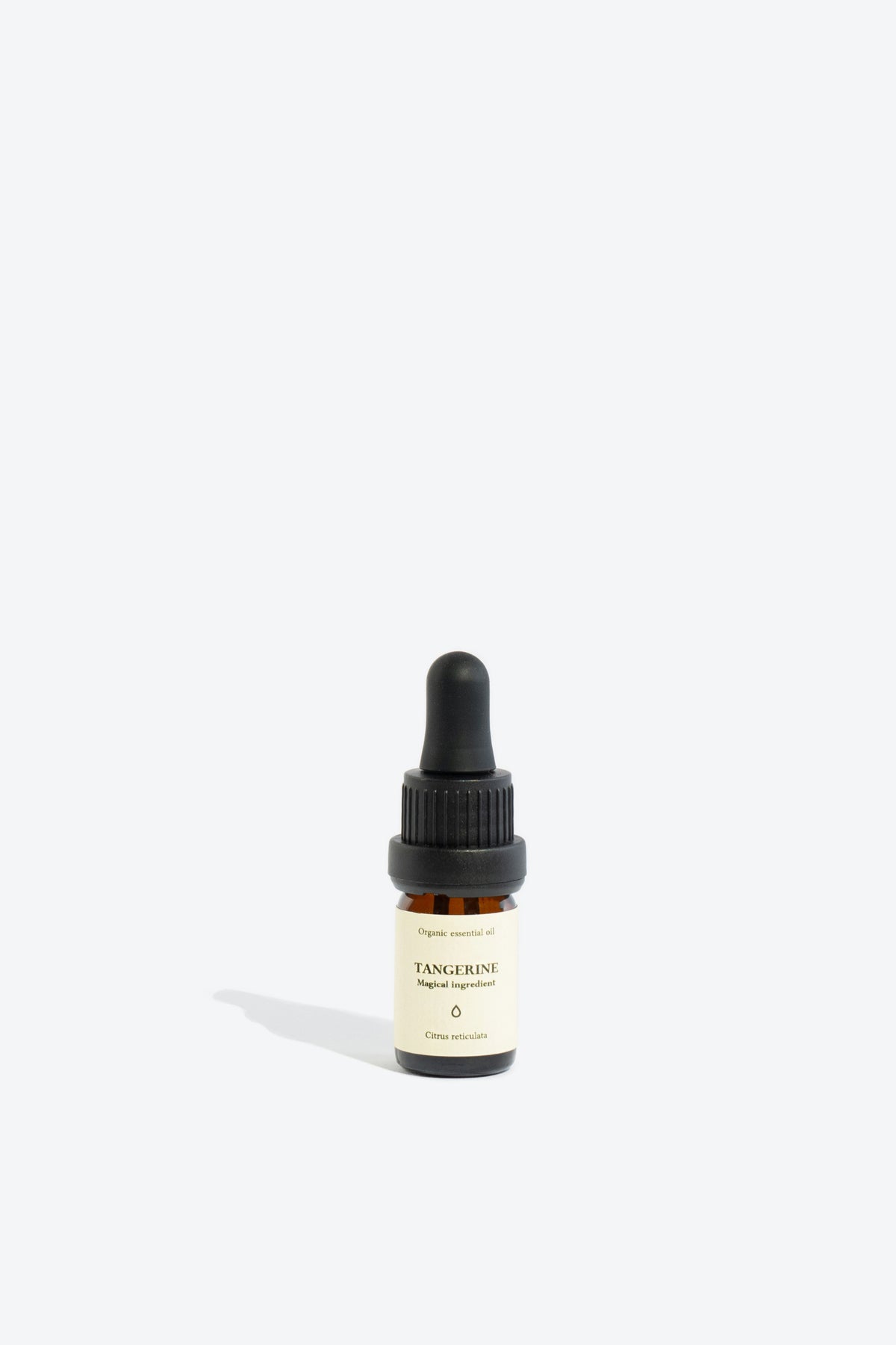 Close-up of TANGERINE essential oil bottle and dropper
