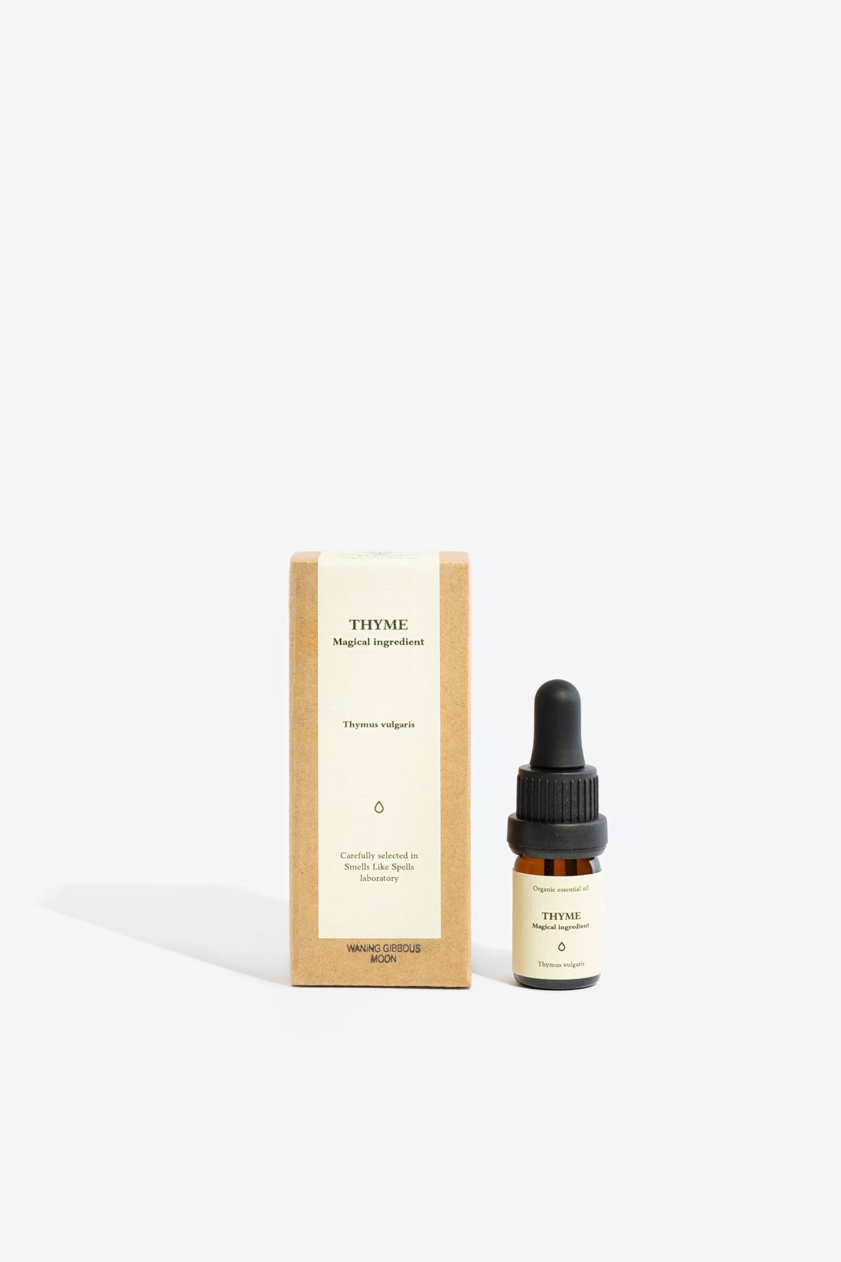 Close-up of THYME essential oil bottle and glass pipette